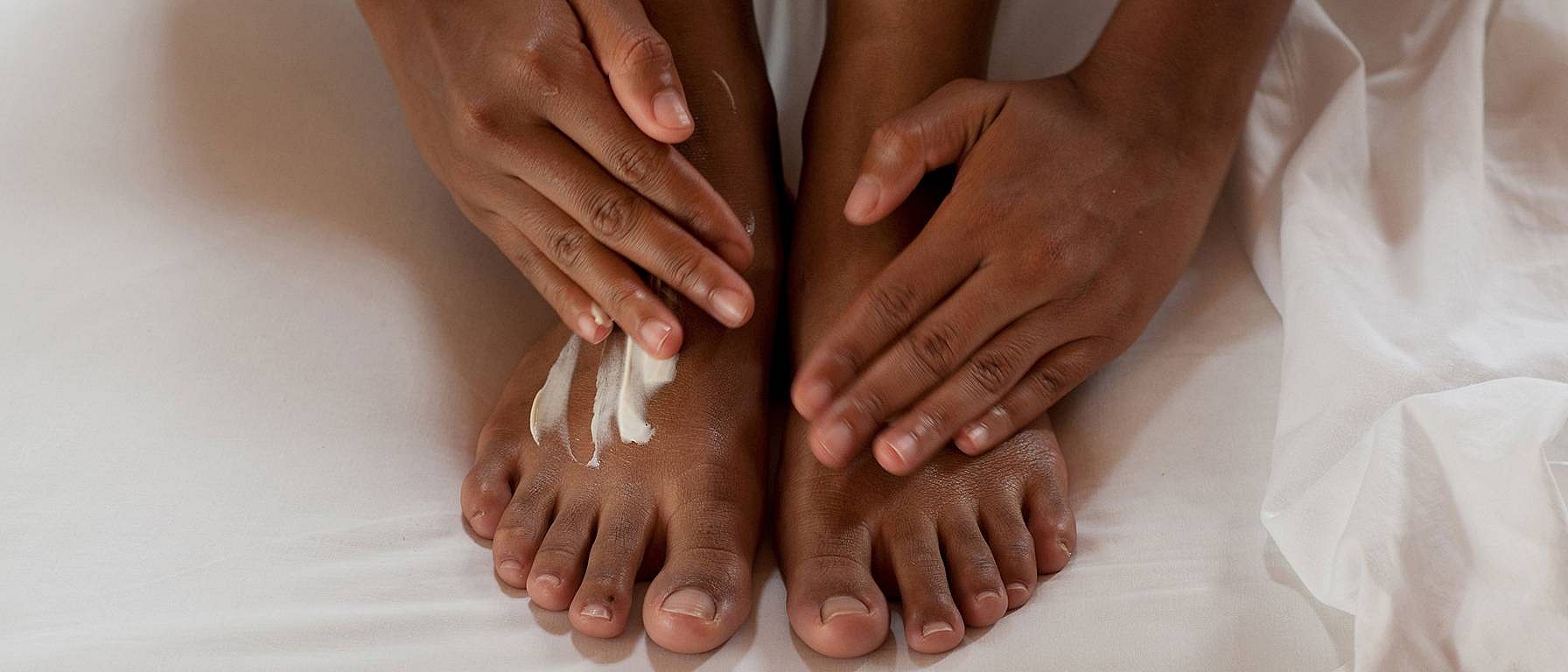 Woman creaming her feet